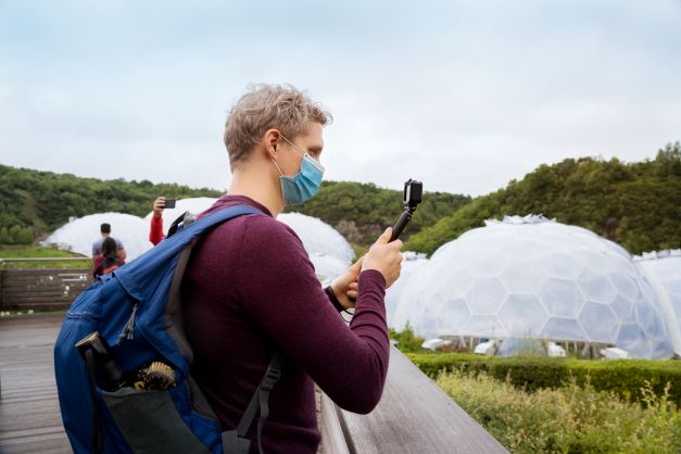 man taking a photo of the eden project in cornwall